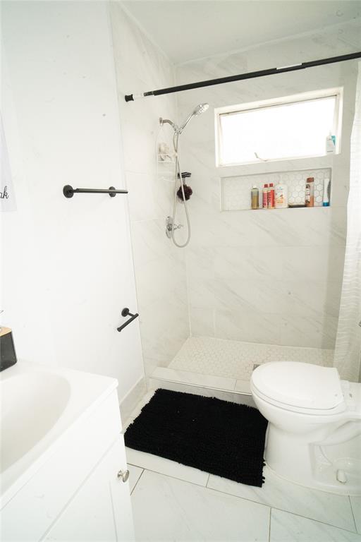 2136 Ridgeway Street Arlington, TX 76010 - Photo 12 of 32 a bathroom with a sink a toilet and shower