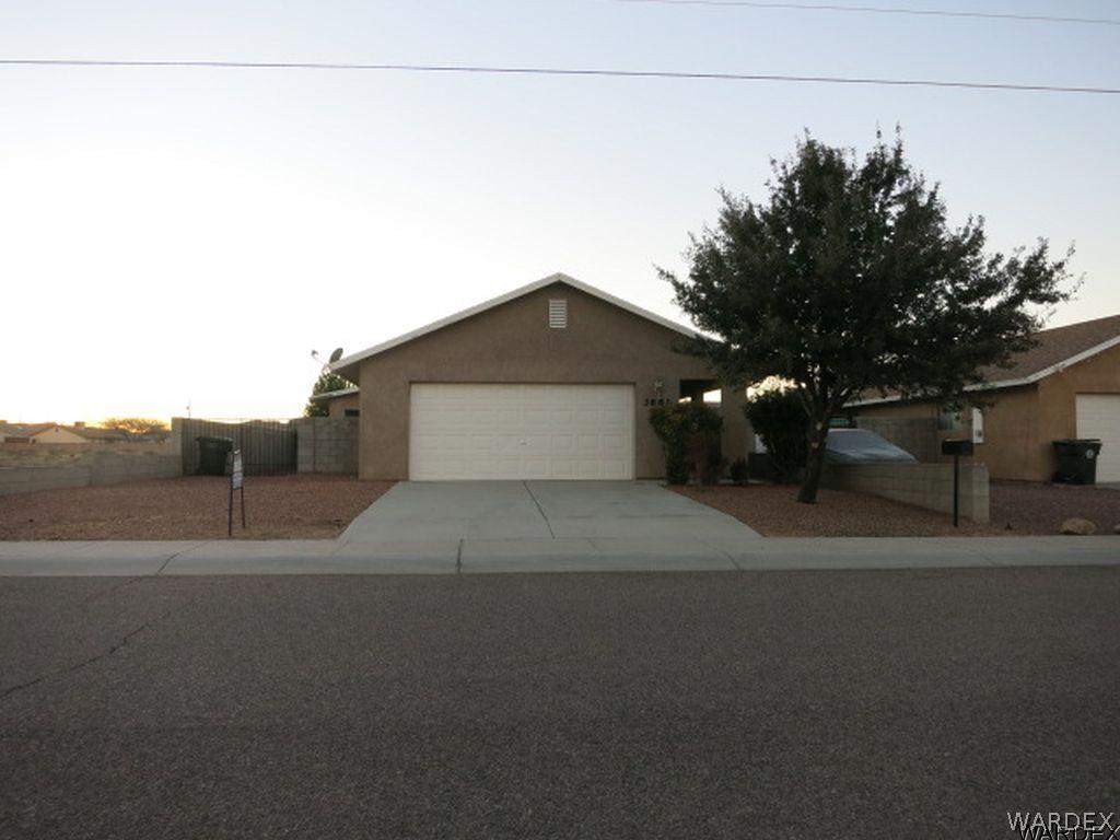 3661 North Kenneth Road Kingman, AZ 86409 - Photo 17 of 18 a front view of a house with a garage