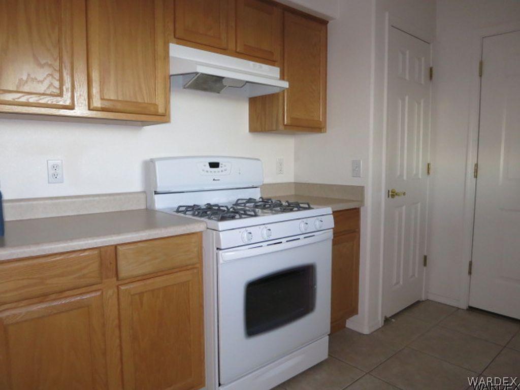 3661 North Kenneth Road Kingman, AZ 86409 - Photo 4 of 18 a kitchen with granite countertop cabinets stainless steel appliances and a sink