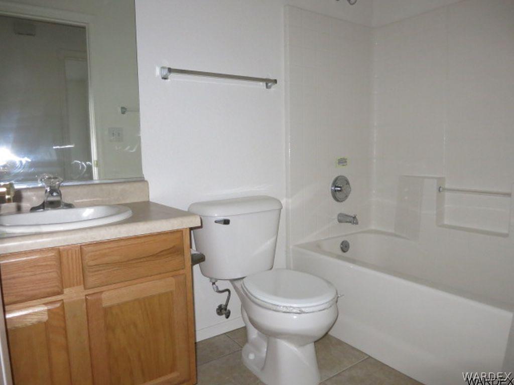 3661 North Kenneth Road Kingman, AZ 86409 - Photo 10 of 18 a bathroom with a sink a toilet and shower