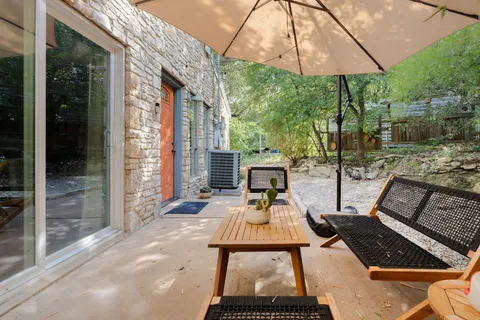 a table and chairs in the patio of a house