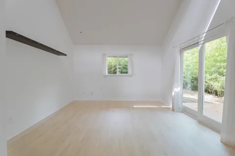 wooden floor in an empty room with a window