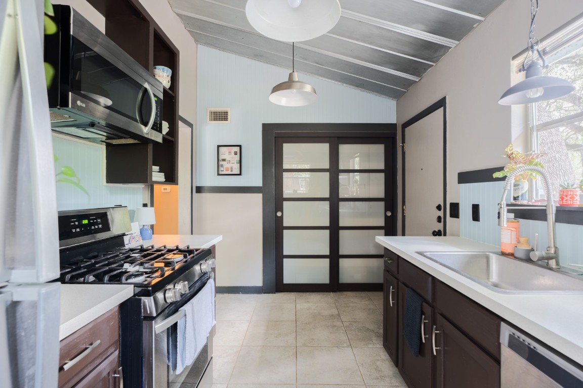 3301 Doolin Drive Austin, TX 78704 - Photo 5 of 32 a kitchen with stainless steel appliances granite countertop a sink stove and cabinets