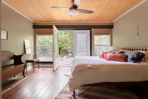 a bedroom with a bed and a window