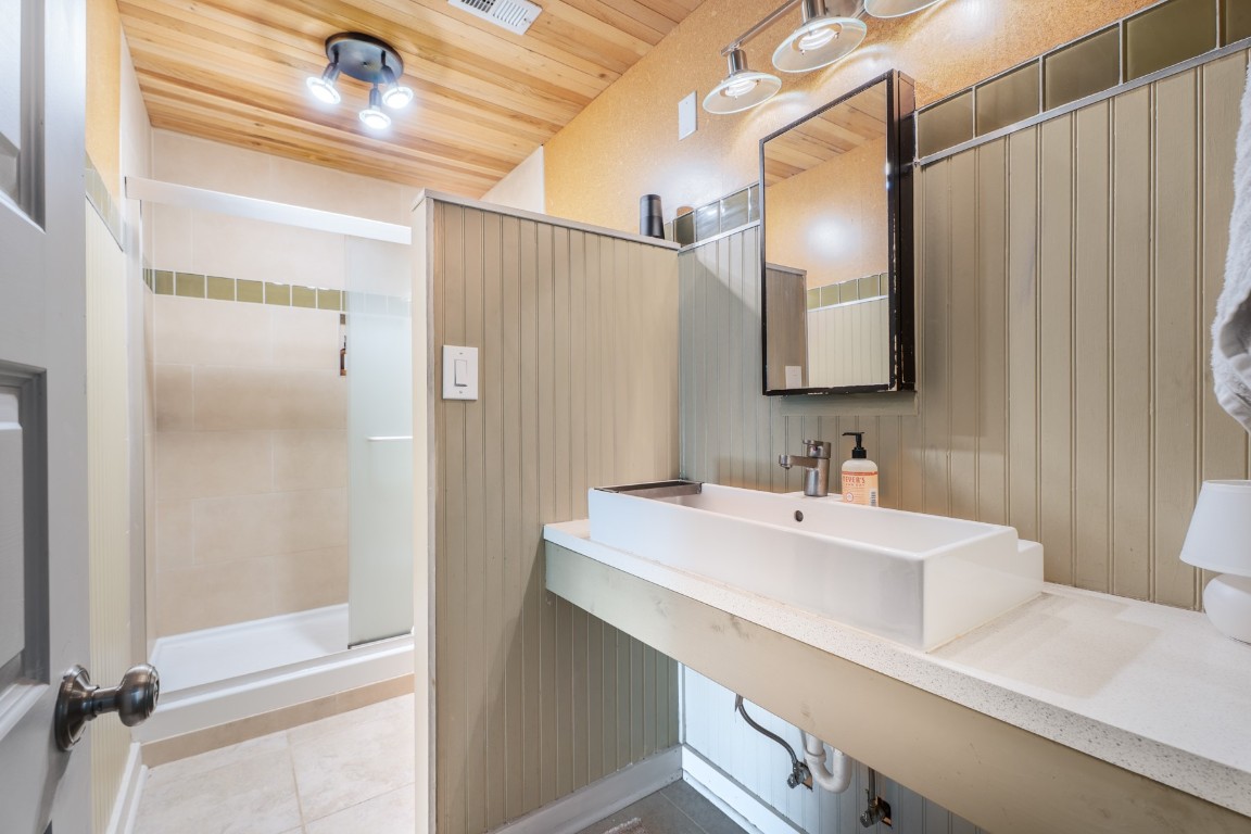 3301 Doolin Drive Austin, TX 78704 - Photo 8 of 32 a bathroom with a sink a mirror and a shower