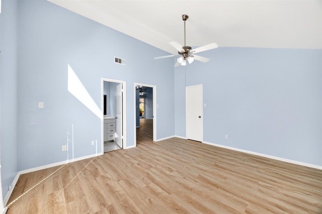 17 April Point Drive North Conroe, TX 77356 - Photo 27 of 42 a view of a bedroom with a ceiling fan window and closet