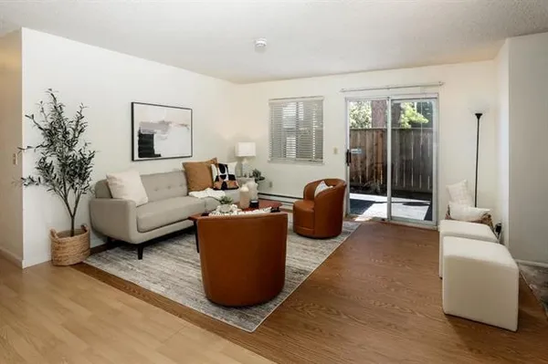 a living room with furniture and a potted plant