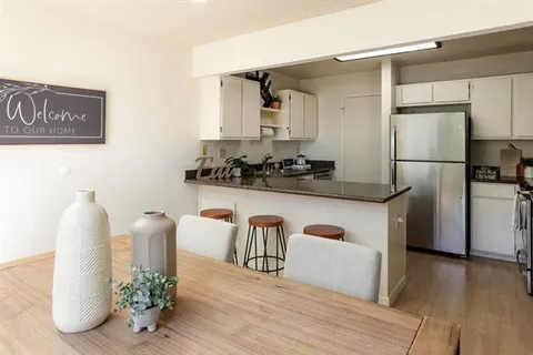 a kitchen with stainless steel appliances granite countertop a refrigerator and a stove