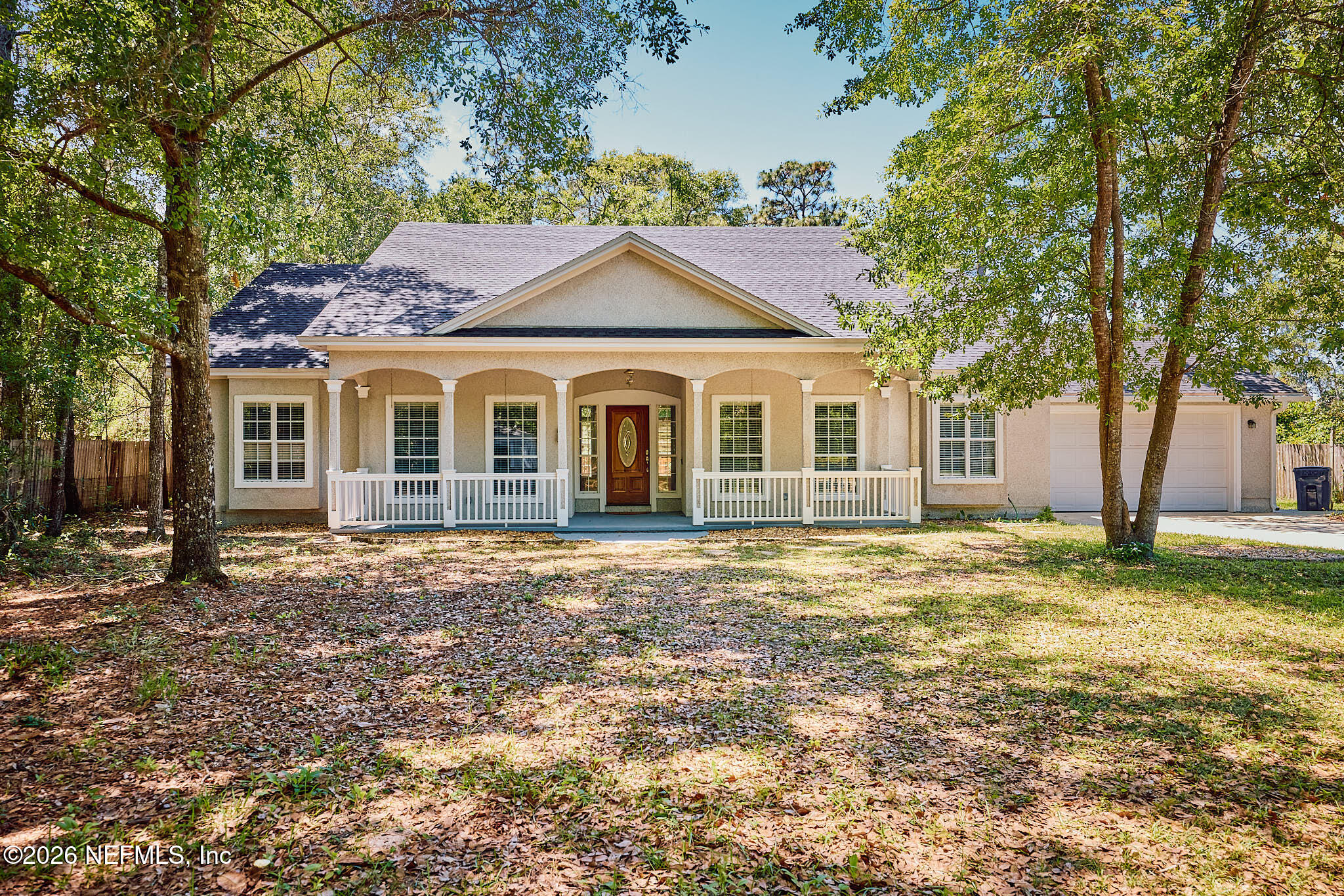 85404 Burmeister Road Fernandina Beach, FL 32034 - Photo 1 of 53 a front view of a house with a garden