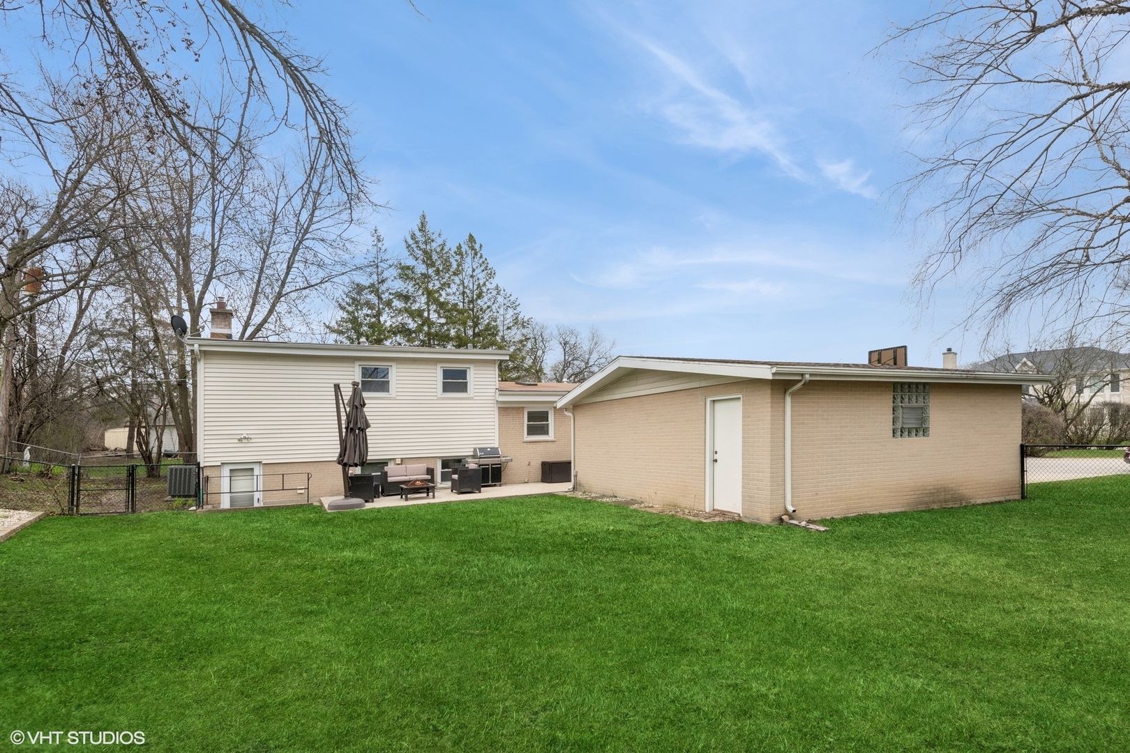 418 Warren Road Glenview, IL 60025 - Photo 20 of 24 a view of a white house with a big yard and large trees