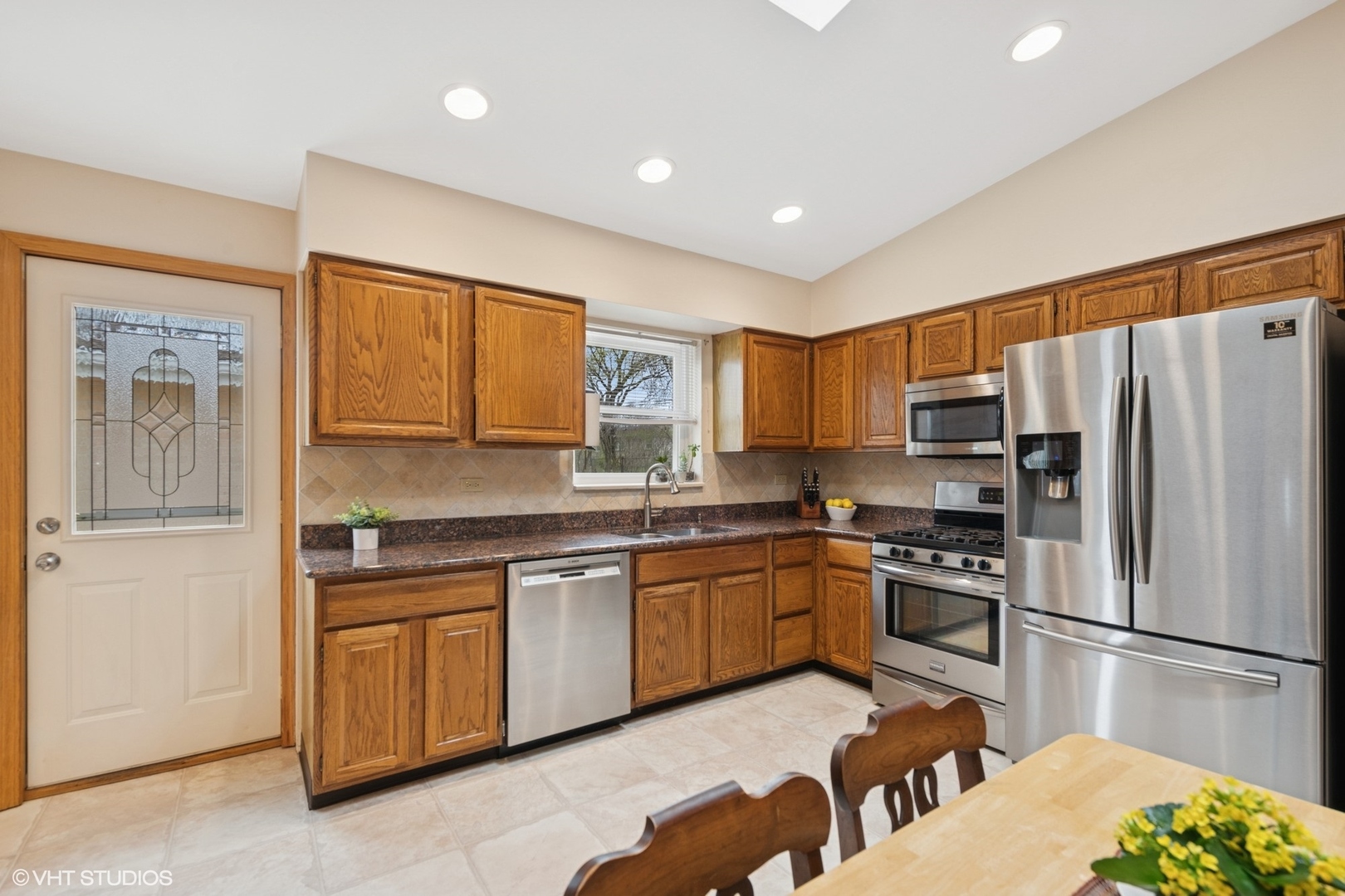 418 Warren Road Glenview, IL 60025 - Photo 5 of 24 a kitchen with stainless steel appliances granite countertop a refrigerator sink and stove