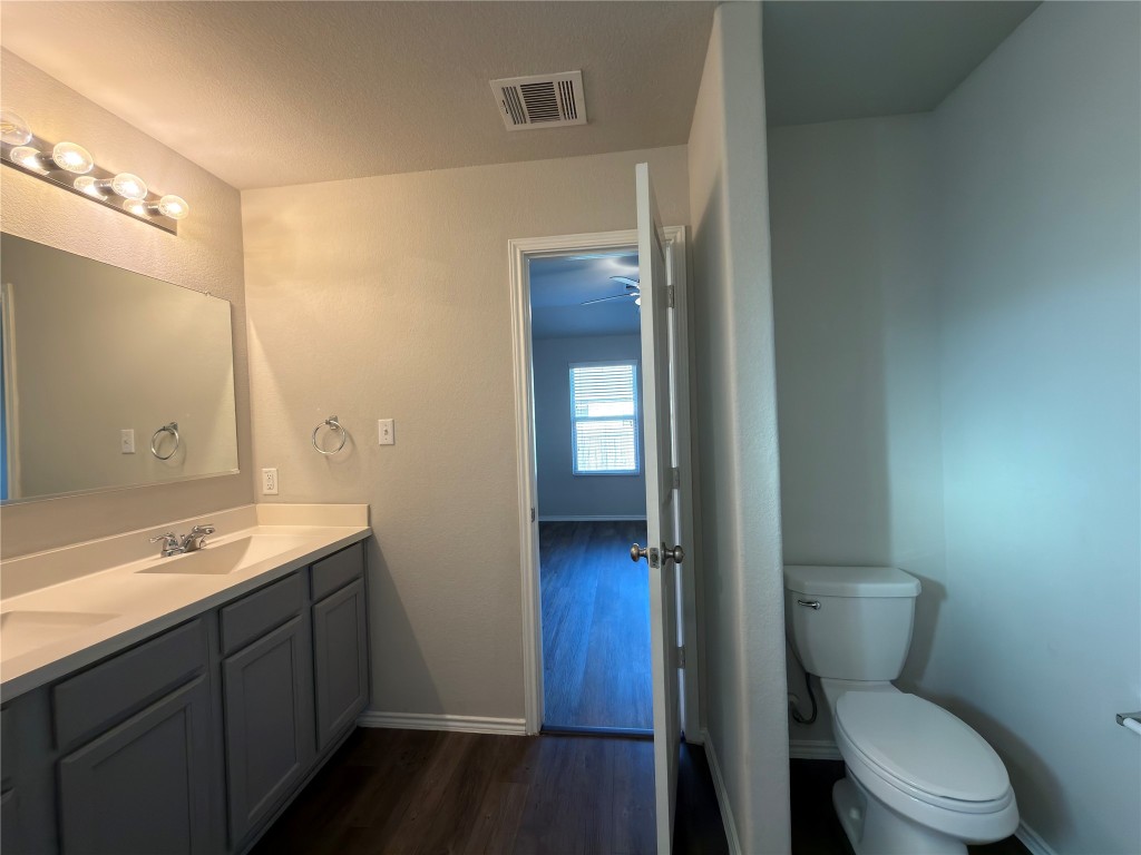 21700 Urraca Lane Pflugerville, TX 78660 - Photo 18 of 40 a bathroom with a toilet a sink and mirror