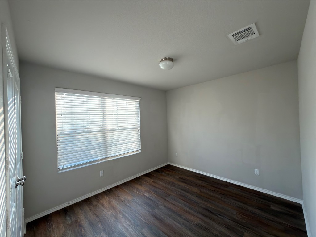 21700 Urraca Lane Pflugerville, TX 78660 - Photo 20 of 40 an empty room with wooden floor and windows