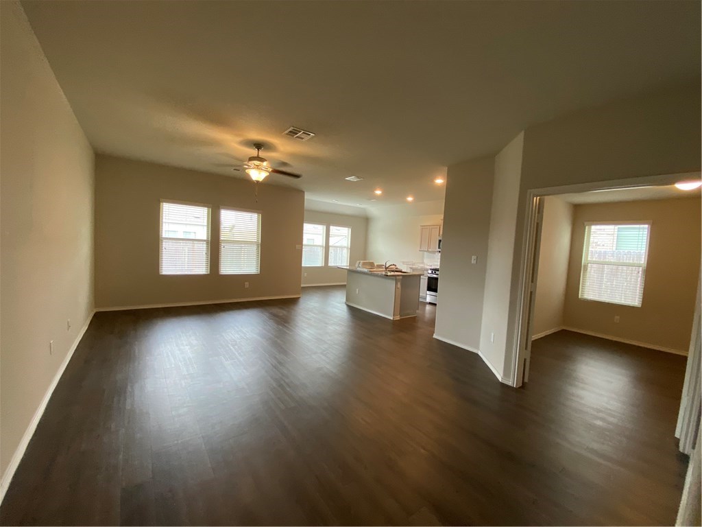 21700 Urraca Lane Pflugerville, TX 78660 - Photo 25 of 40 a view of an empty room with a window and wooden floor