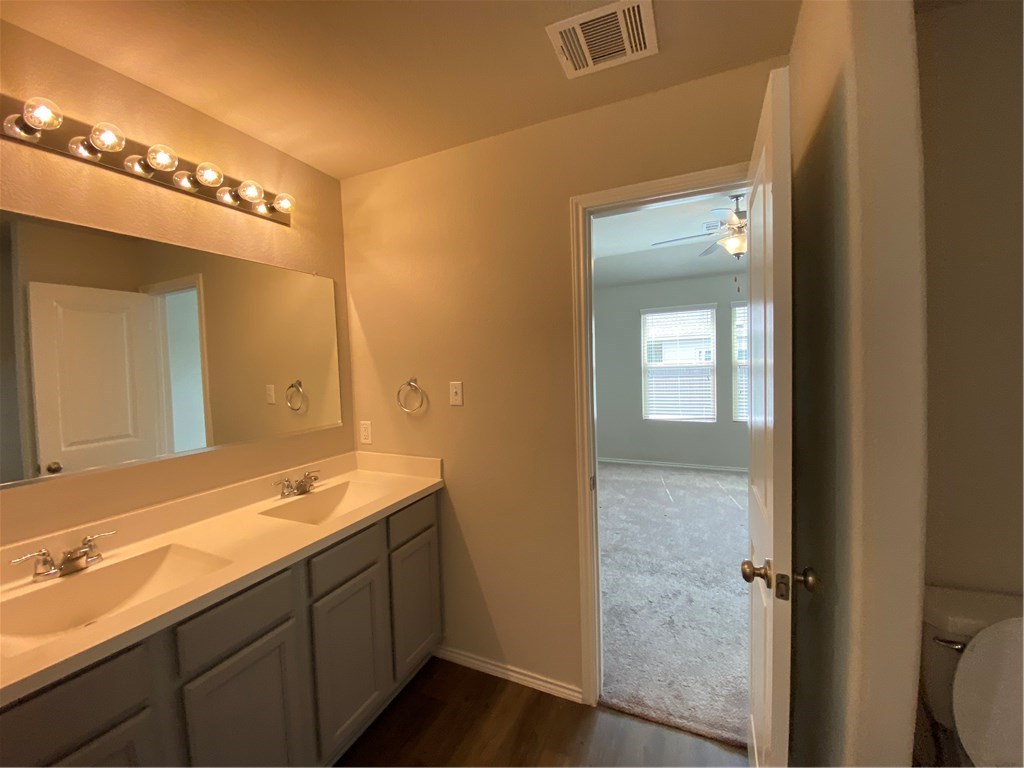 21700 Urraca Lane Pflugerville, TX 78660 - Photo 30 of 40 a bathroom with a double vanity sink and a mirror