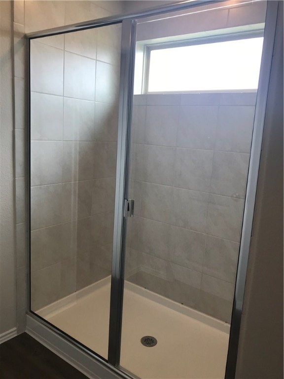 21700 Urraca Lane Pflugerville, TX 78660 - Photo 34 of 40 a bathroom with a glass shower door