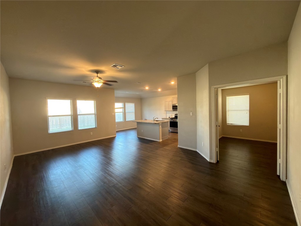 21700 Urraca Lane Pflugerville, TX 78660 - Photo 4 of 40 a view of empty room with wooden floor and fan