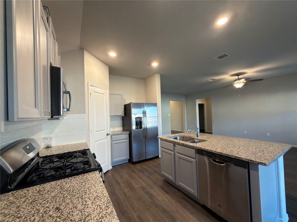 21700 Urraca Lane Pflugerville, TX 78660 - Photo 8 of 40 a kitchen with a sink stove and refrigerator