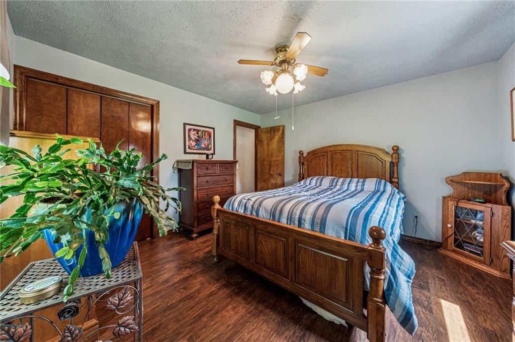 922 Old Ridge Road Avella, PA 15312 - Photo 26 of 50 a bedroom with a bed a bookshelf and wooden floor
