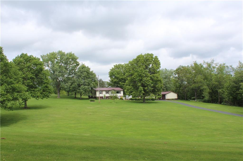922 Old Ridge Road Avella, PA 15312 - Photo 3 of 50 a view of a grassy field with trees in the background