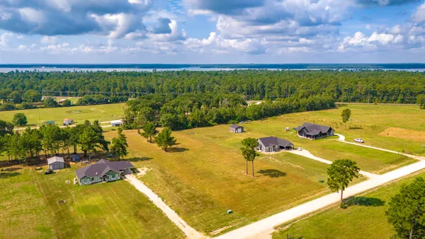 a view of a swimming pool and lake in back