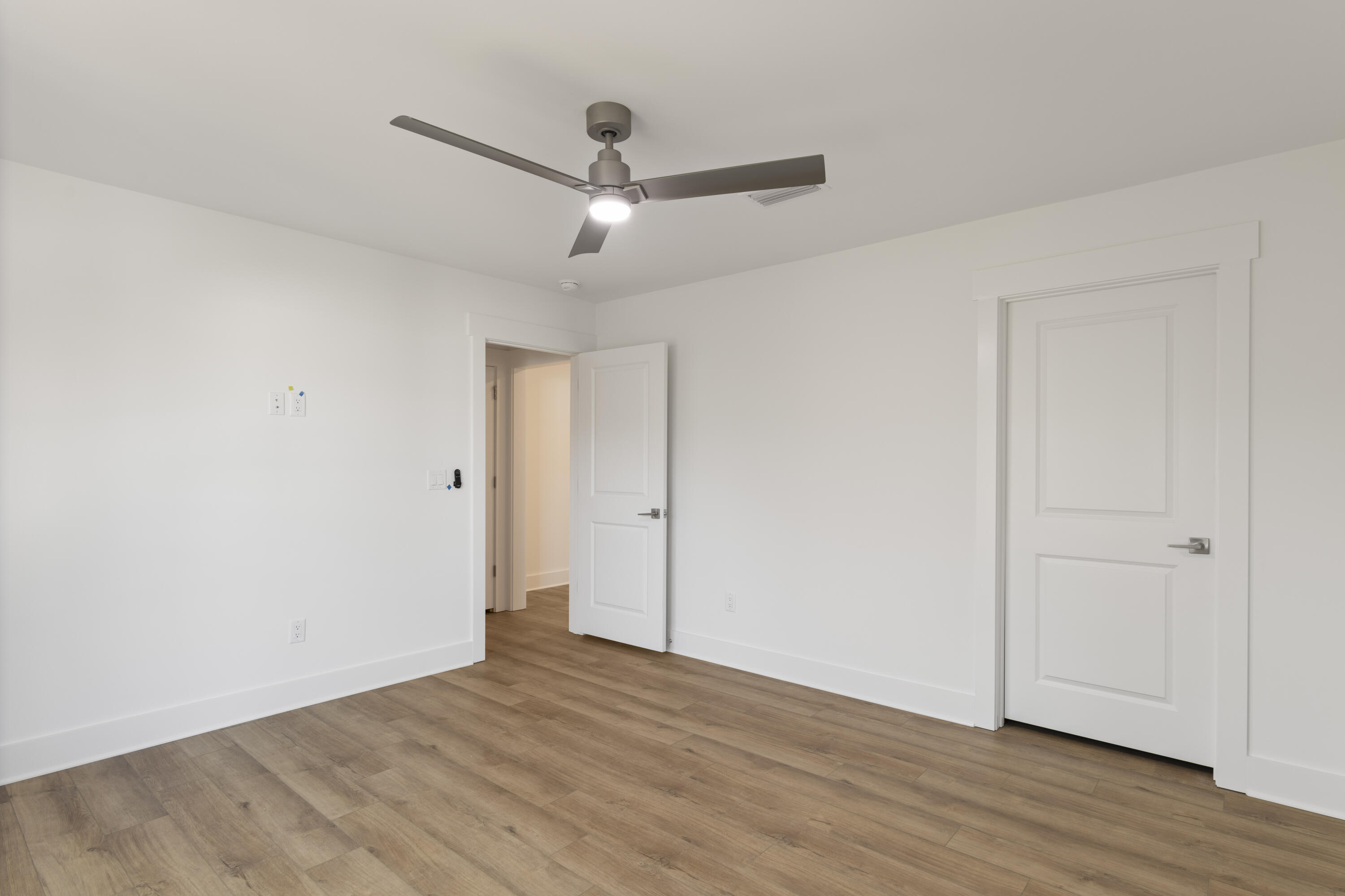 310 Channel Shl Drive, Unit LOT 13 Santa Rosa Beach, FL 32459 - Photo 67 of 77 an empty room with wooden floor ceiling fan and windows