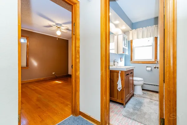 a spacious bathroom with a sink toilet and mirror