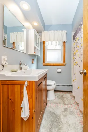 a bathroom with a sink a mirror and a bathtub