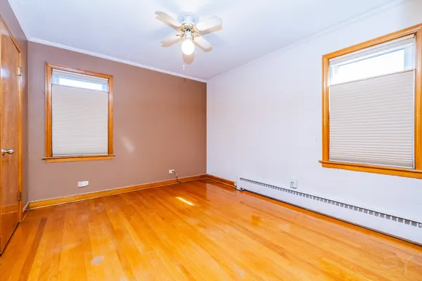 a view of empty room with window and ceiling fan