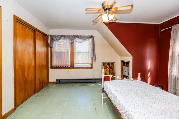 a bedroom with a bed and window