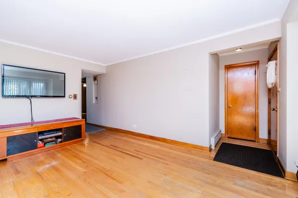 a room with natural light and wooden floor