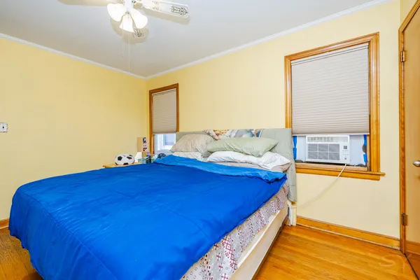 a bed sitting in a bedroom next to a window