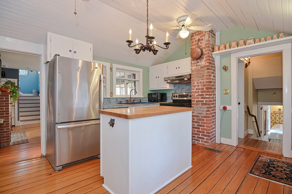 1919 Main Road Westport, MA 02791 - Photo 26 of 42 a view of a kitchen with a refrigerator a ceiling fan and wooden floor