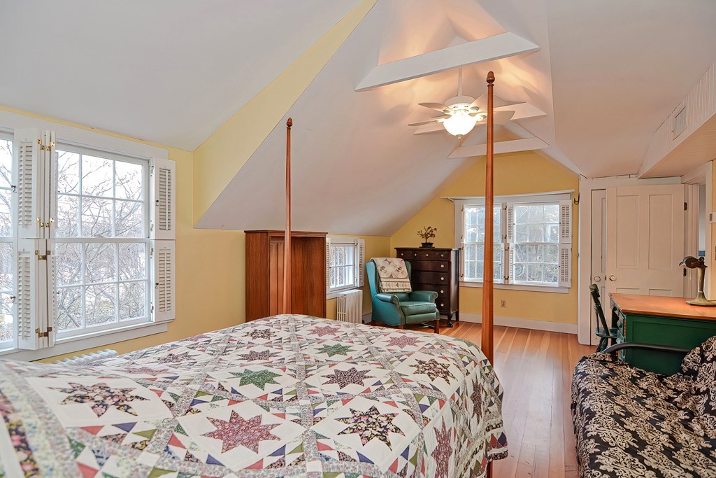 1919 Main Road Westport, MA 02791 - Photo 31 of 42 a bedroom with a bed and a chandelier