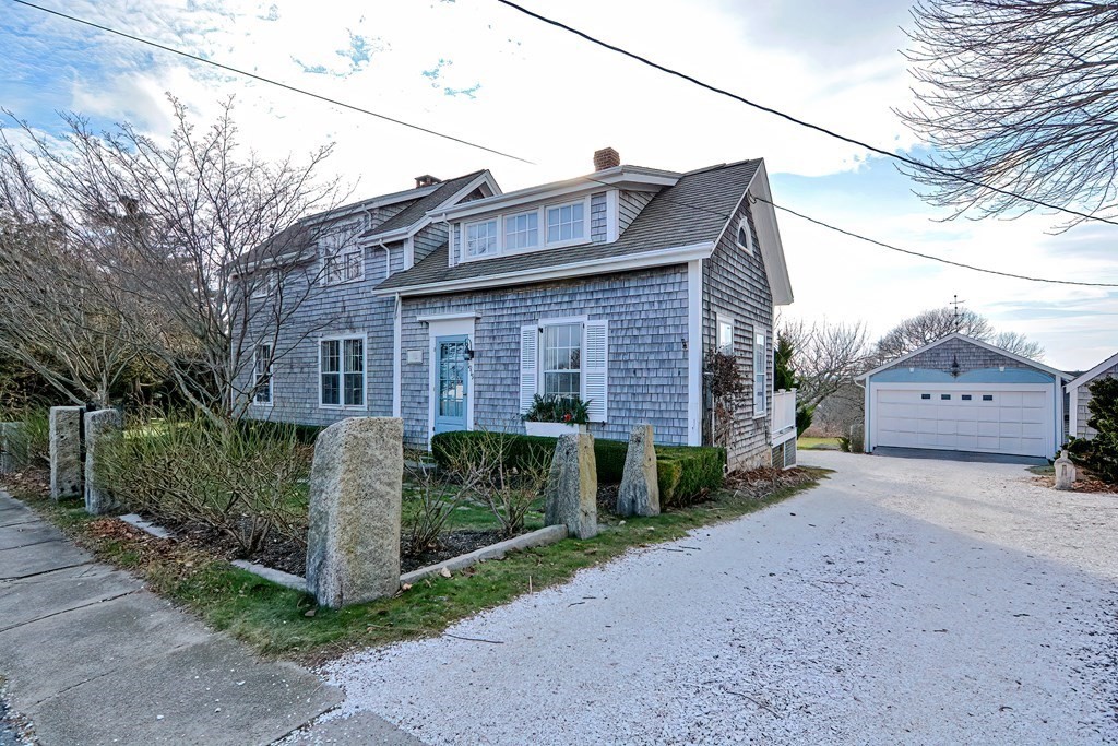 1919 Main Road Westport, MA 02791 - Photo 33 of 42 a front view of a house with a garden and trees