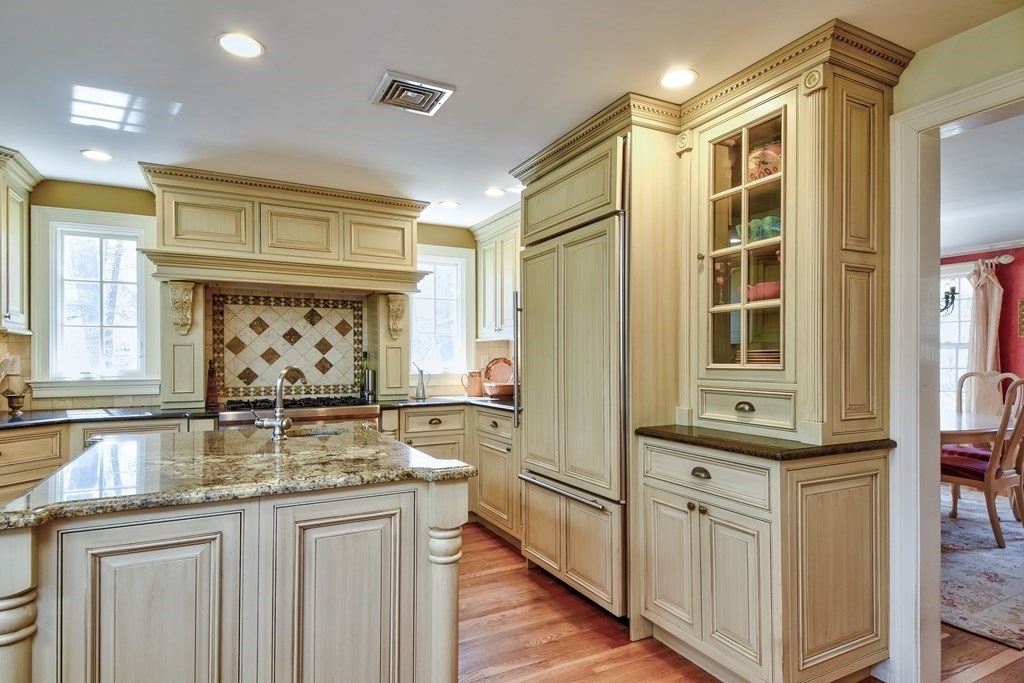 9 Salem Road Wellesley, MA 02481 - Photo 13 of 40 a kitchen with stainless steel appliances granite countertop a sink and cabinets
