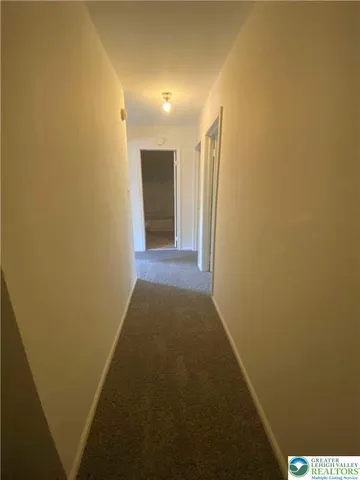 an empty room with a empty space and windows