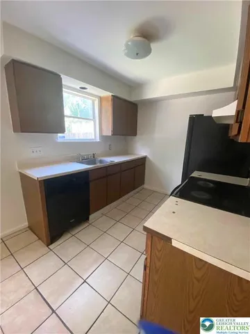 a kitchen with stainless steel appliances a stove a sink a microwave a counter top and cabinets