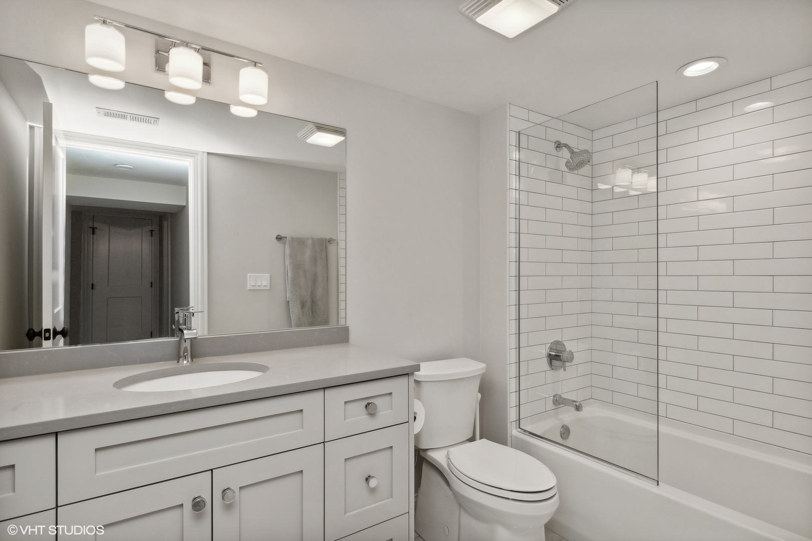 1192 Griffith Road Lake Forest, IL 60045 - Photo 22 of 29 a bathroom with a granite countertop sink a toilet and shower