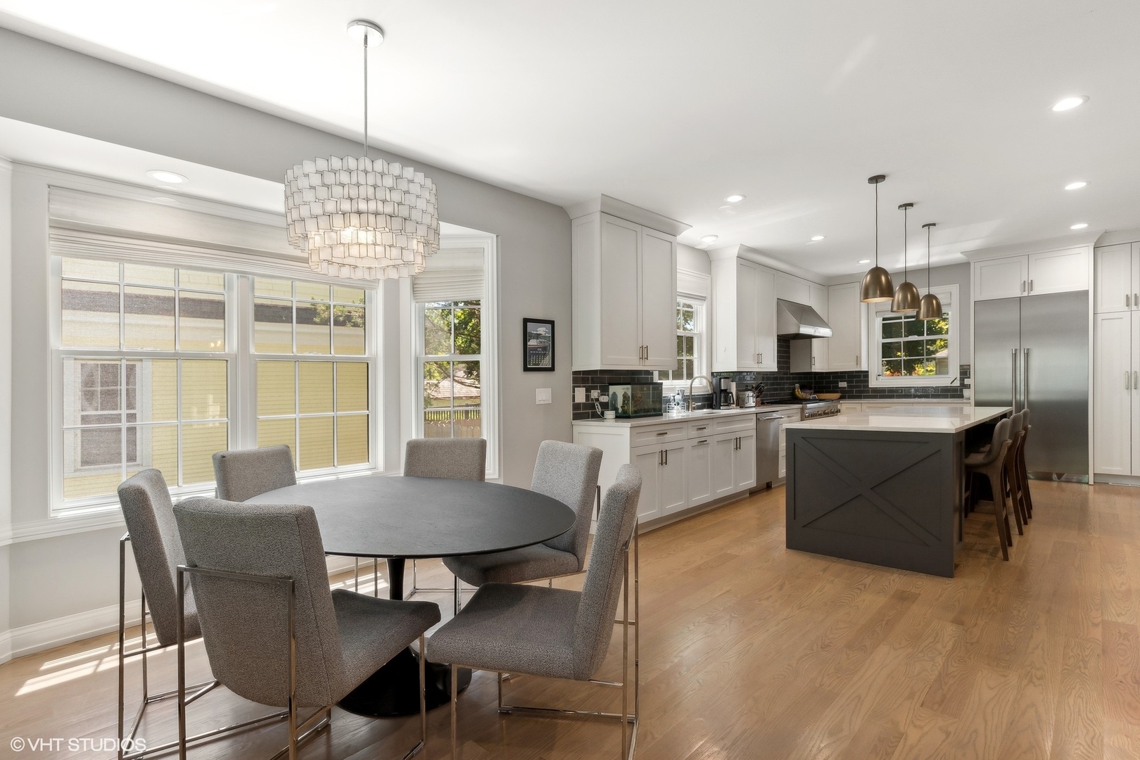 1192 Griffith Road Lake Forest, IL 60045 - Photo 10 of 29 a kitchen with a dining table chairs wooden floor and appliances