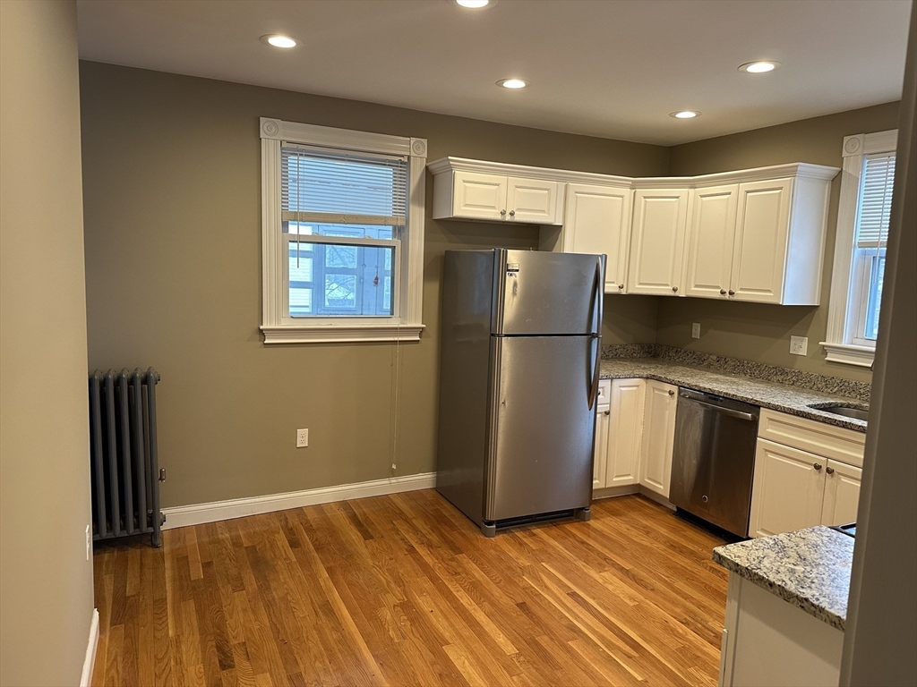 225 Gibson Street, Unit 2 Lowell, MA 01851 - Photo 2 of 13 a refrigerator freezer sitting inside of a kitchen