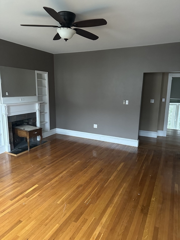 225 Gibson Street, Unit 2 Lowell, MA 01851 - Photo 4 of 13 a view of room with wooden floor and ceiling fan
