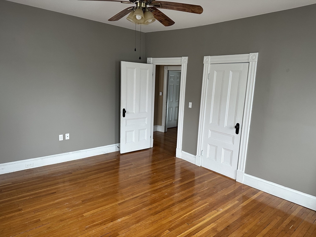 225 Gibson Street, Unit 2 Lowell, MA 01851 - Photo 8 of 13 a view of an empty room with wooden floor