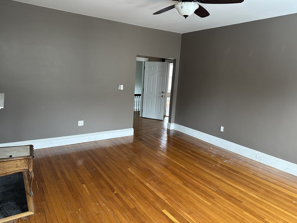 225 Gibson Street, Unit 2 Lowell, MA 01851 - Photo 9 of 13 a view of an empty room with wooden floor