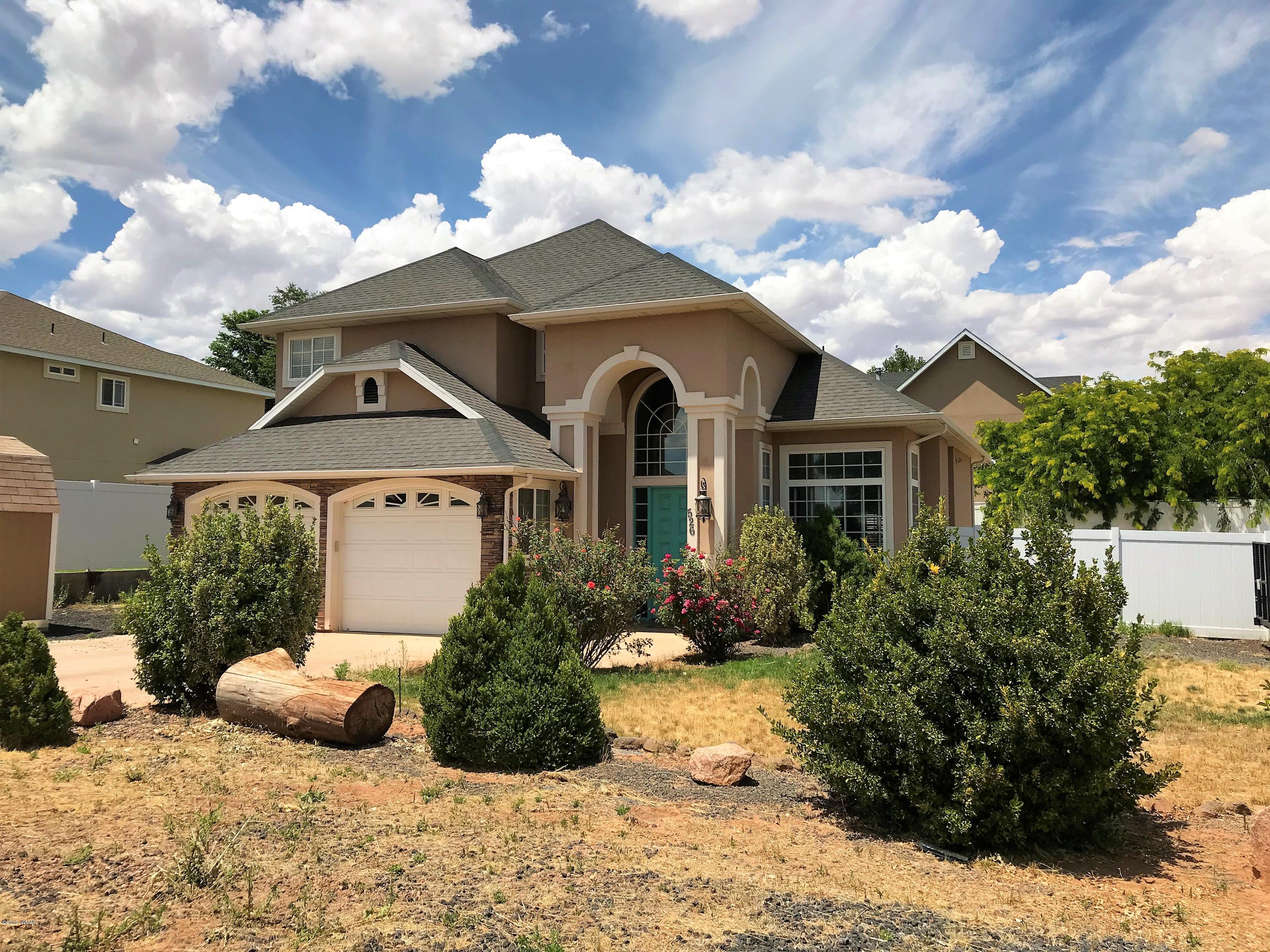 526 South 6th W Street Snowflake, AZ 85937 - Photo 1 of 36 a front view of a house with a yard and potted plants