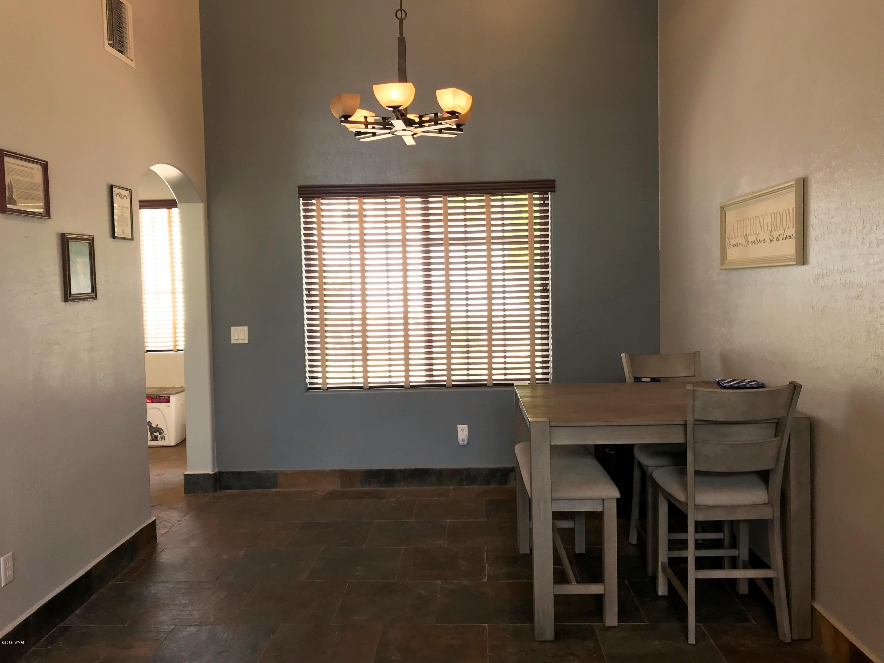 526 South 6th W Street Snowflake, AZ 85937 - Photo 11 of 36 a view of a dining room with furniture and chandelier