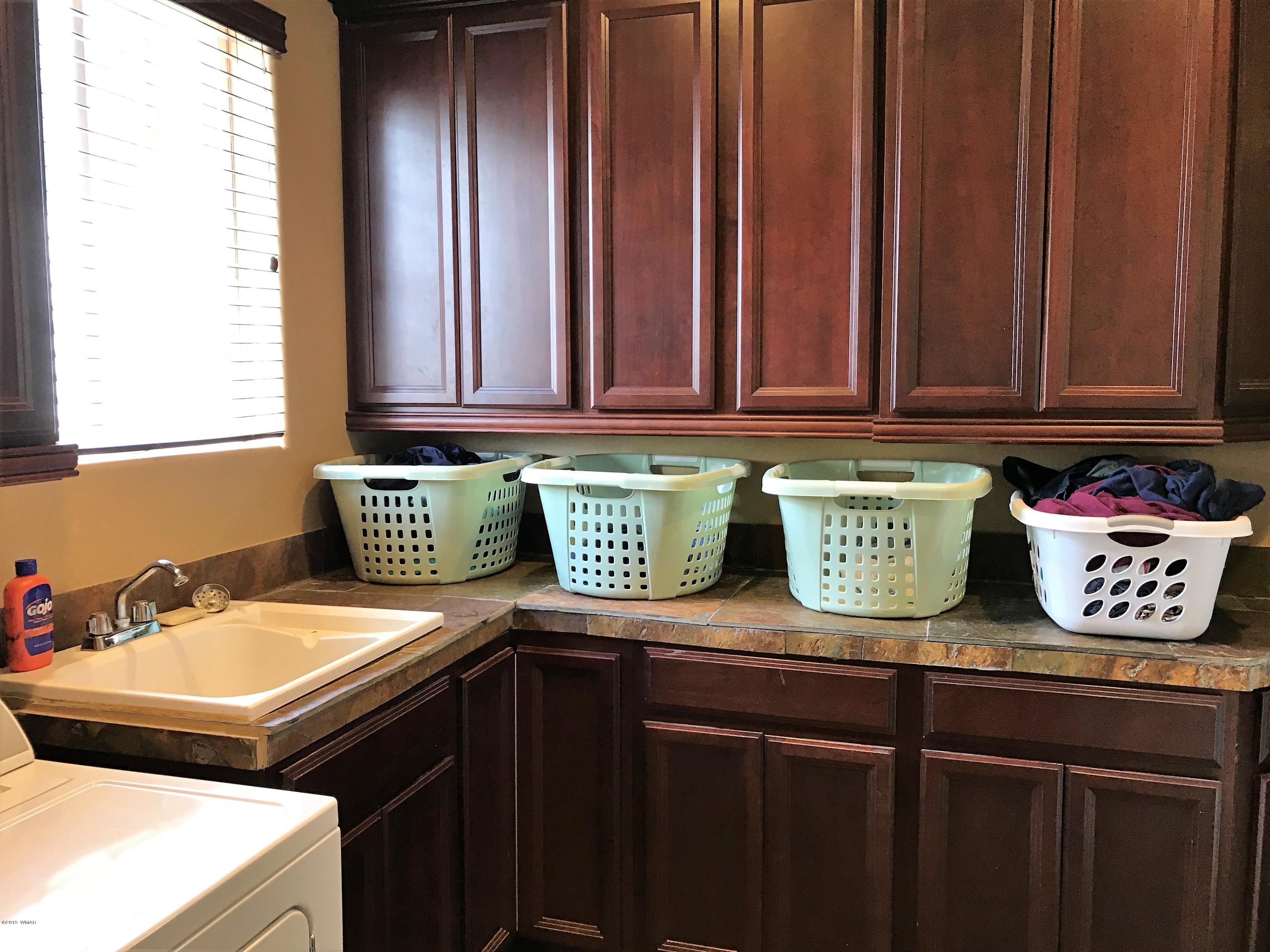 526 South 6th W Street Snowflake, AZ 85937 - Photo 19 of 36 a kitchen with a sink and cabinets