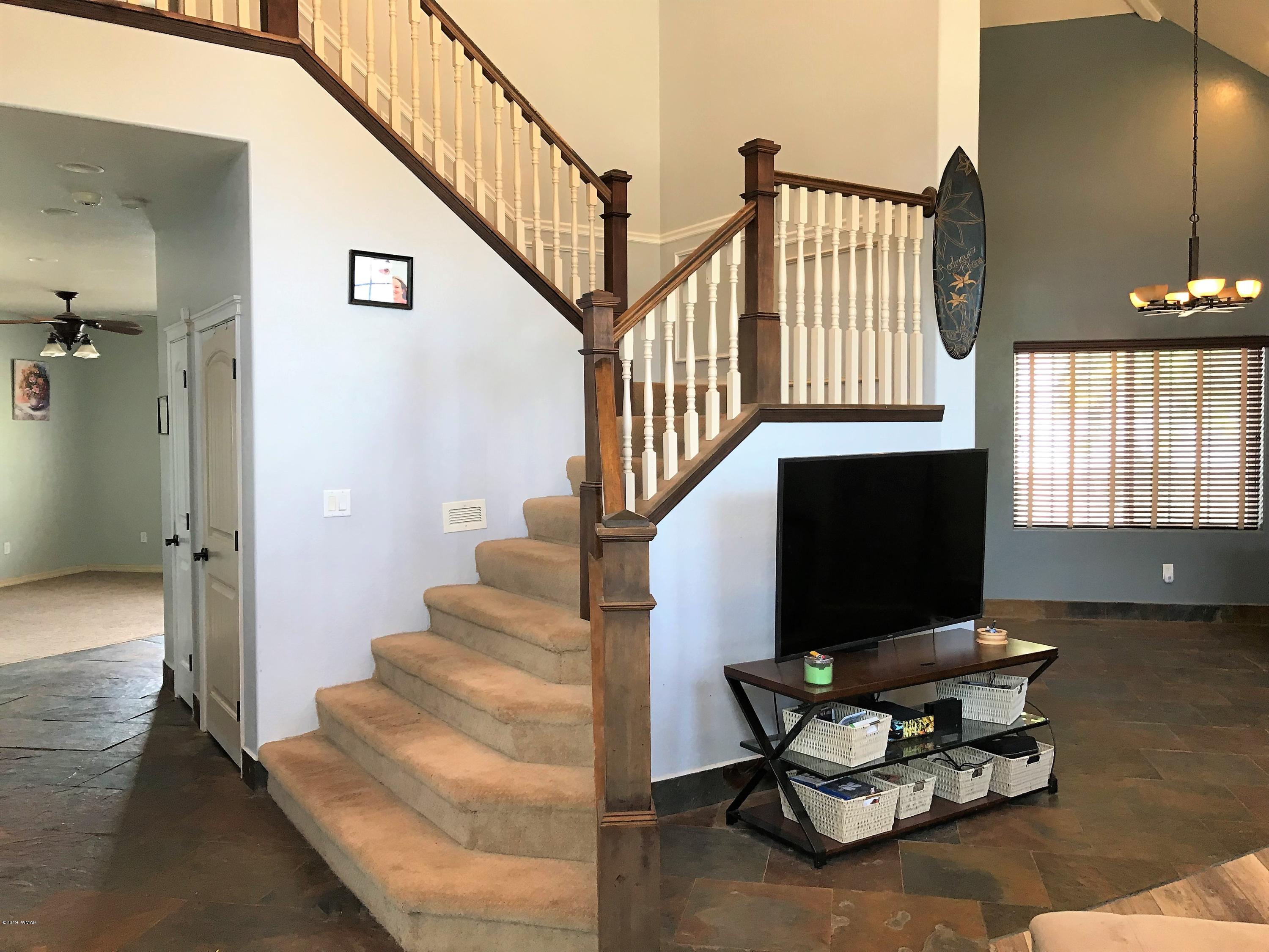 526 South 6th W Street Snowflake, AZ 85937 - Photo 21 of 36 a living room with couches and a dining table with wooden floor