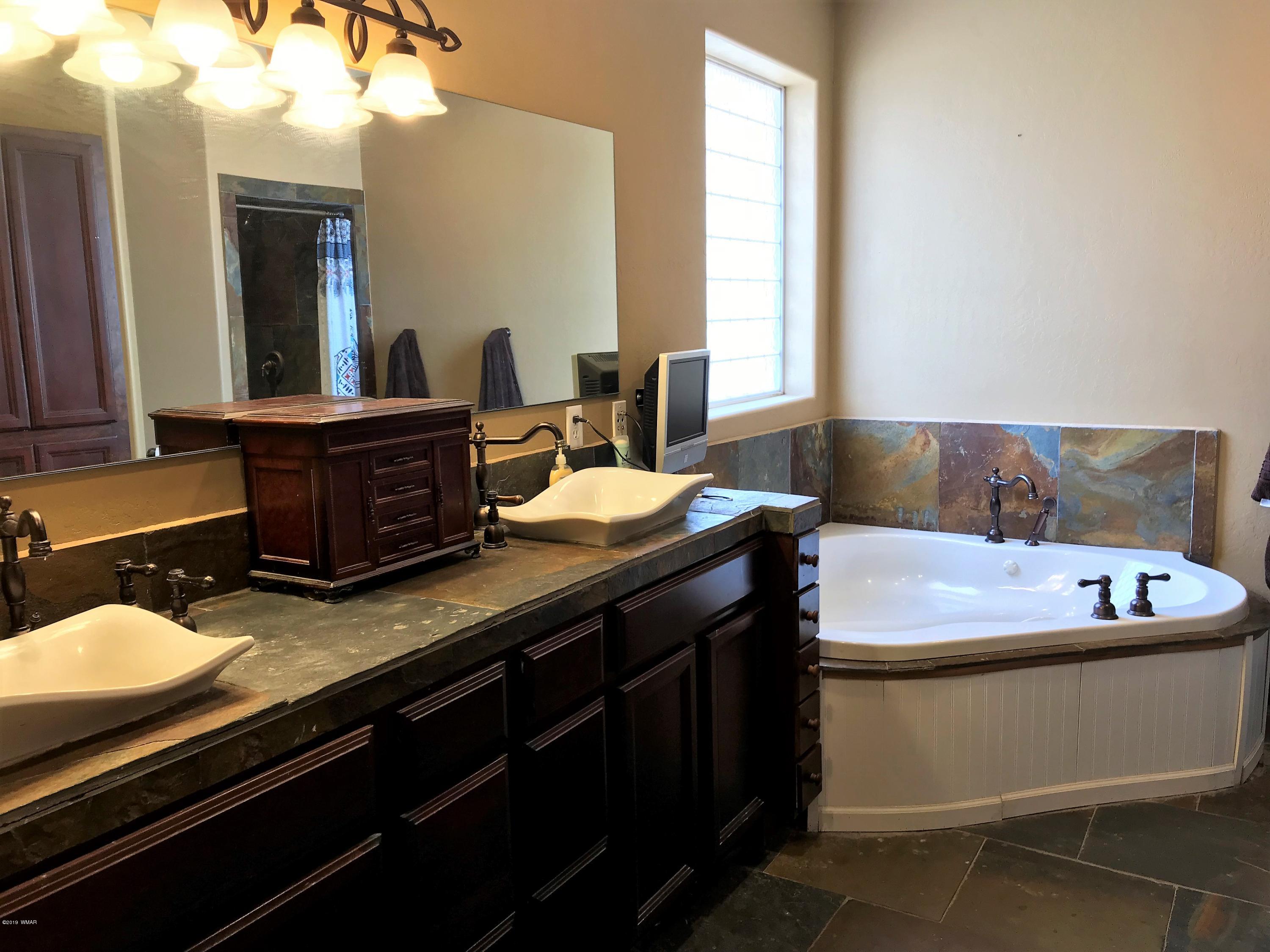 526 South 6th W Street Snowflake, AZ 85937 - Photo 26 of 36 a bathroom with a granite countertop sink and a mirror