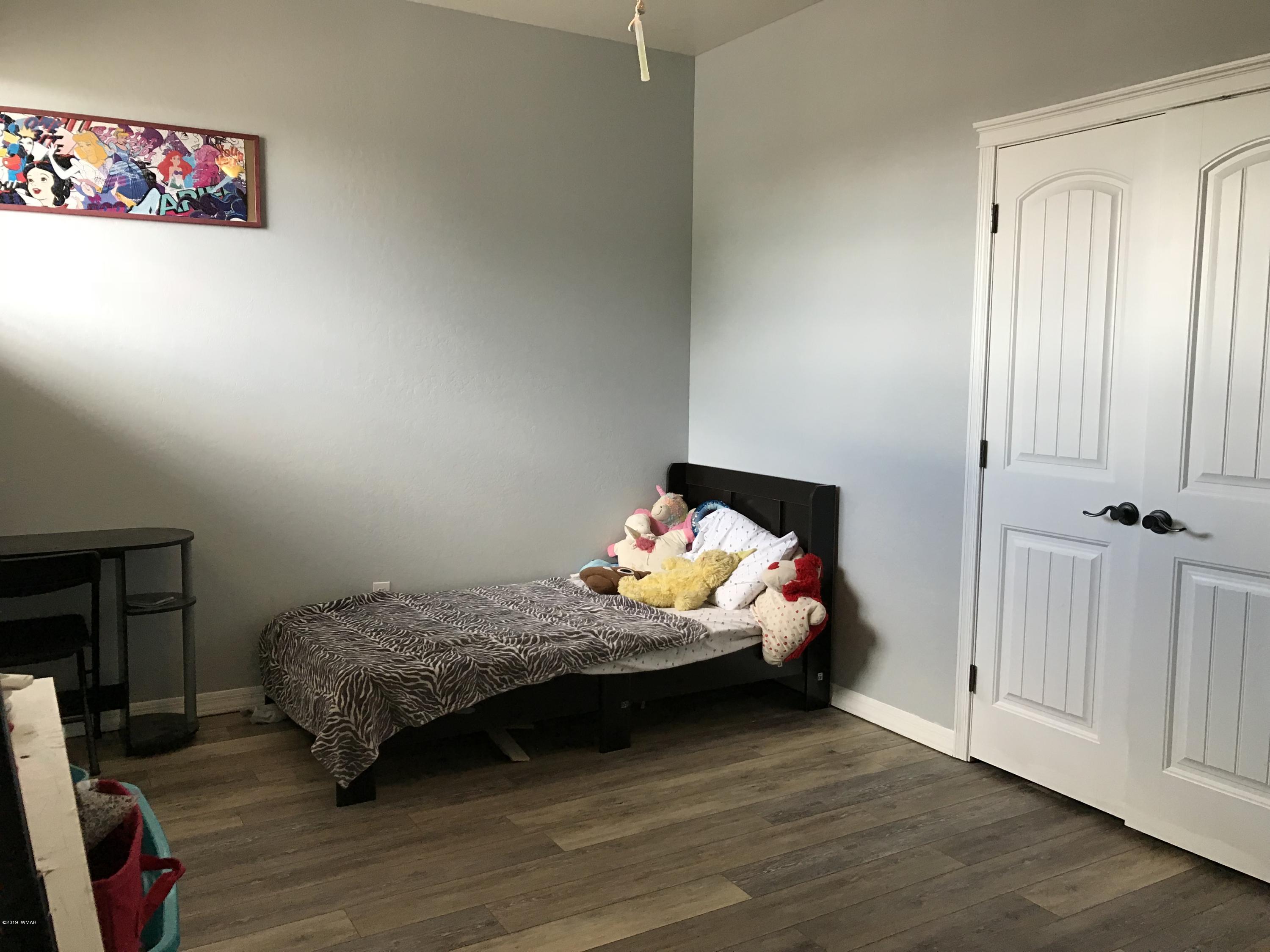 526 South 6th W Street Snowflake, AZ 85937 - Photo 32 of 36 a bedroom with bed and window